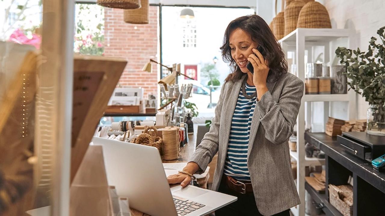 Female business owner talking on a phone.