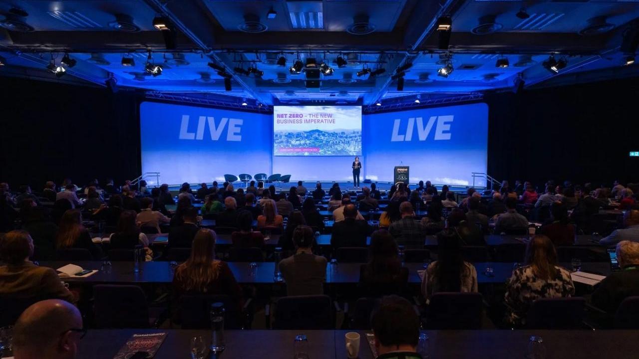 A person on stage in front of an audience 