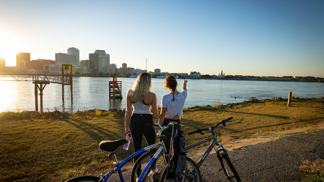 Two people looking at cityscape with bikes next to them