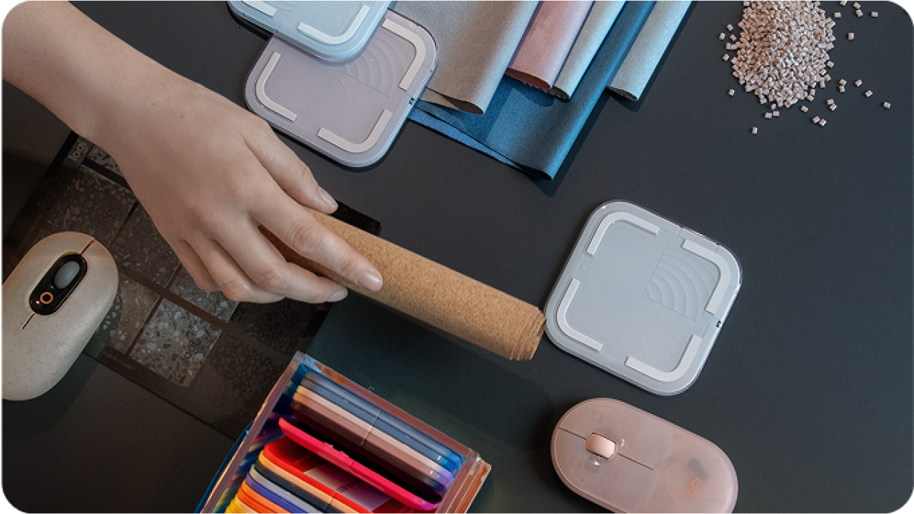 desk with hands and Logitech products shown on top