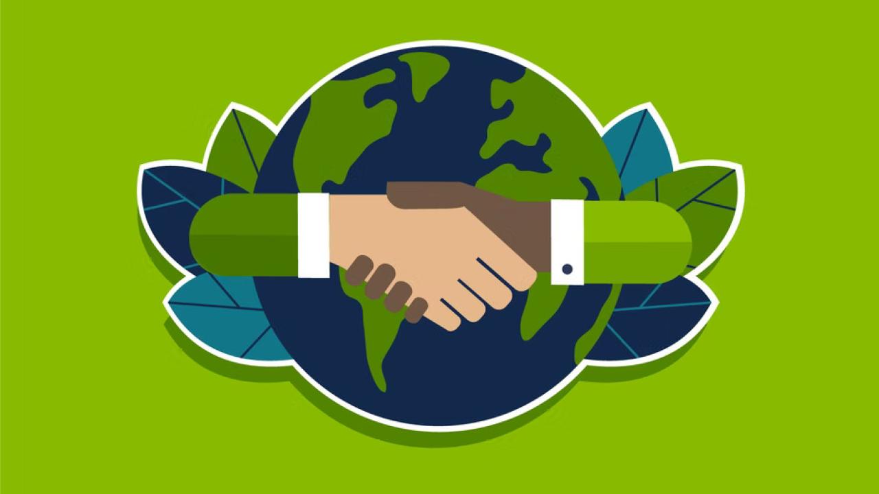 abstract image of two hands shaking in front of a globe with leaves on the sides