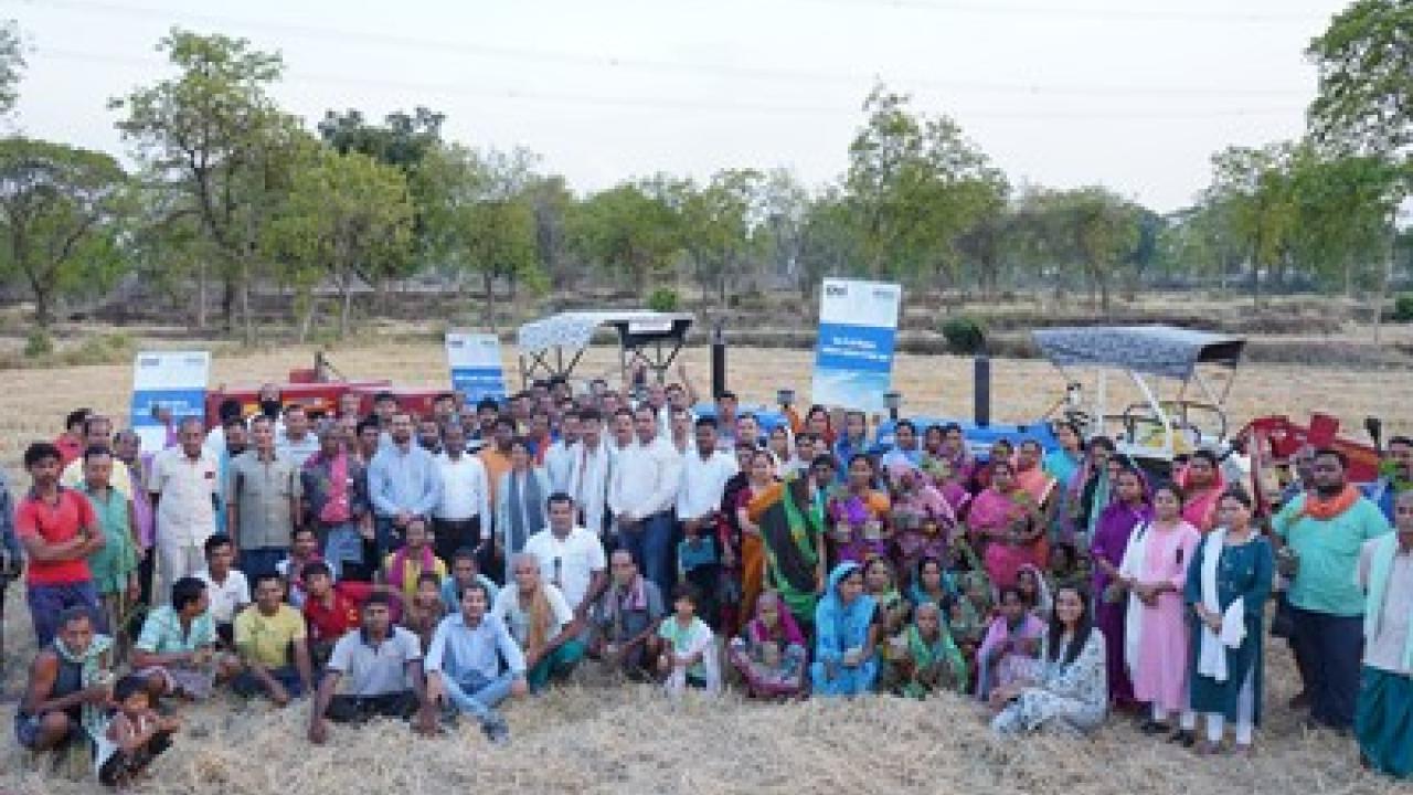 Large group standing and sitting together outside