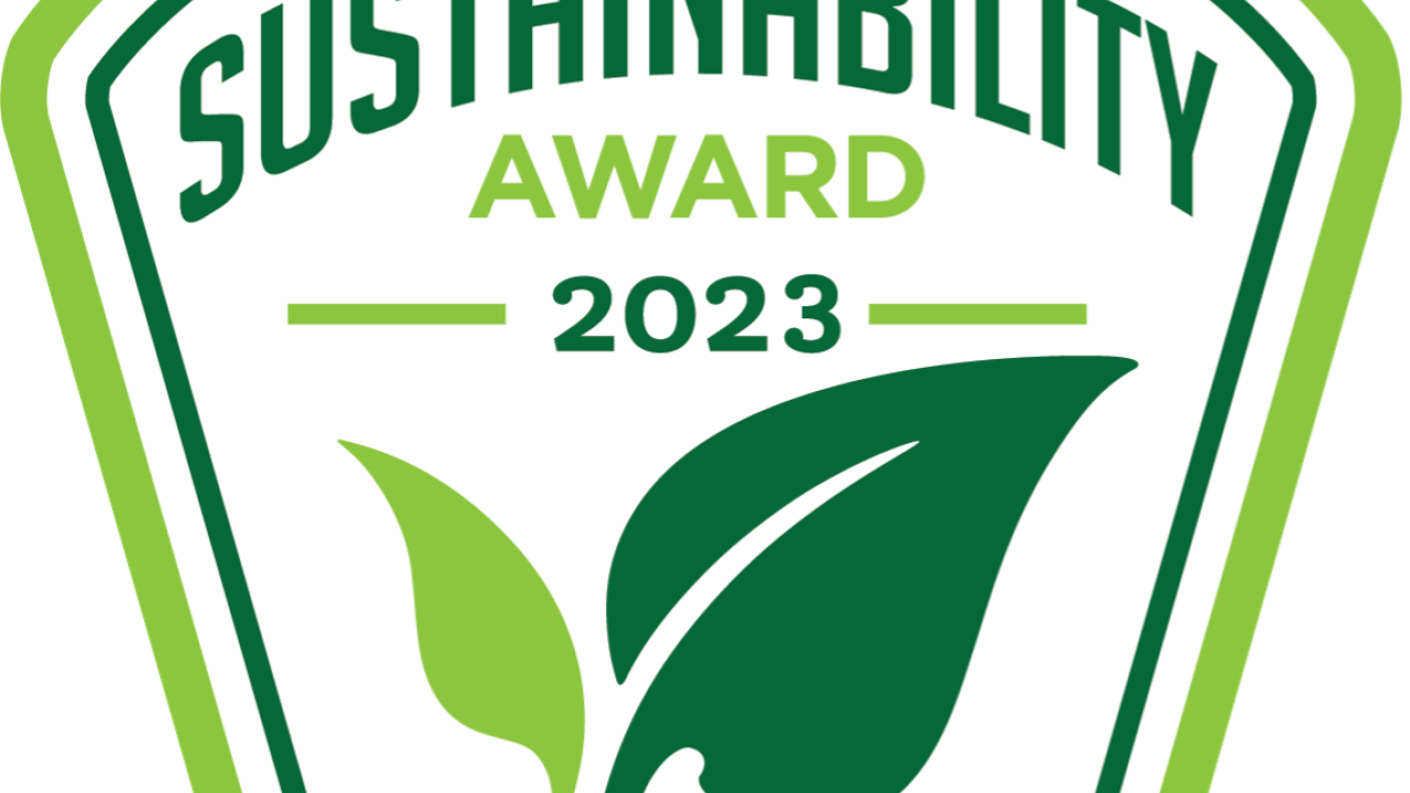 Dark and light green colors make up two leafs of a plant that is placed below the words, "Sustainability Award 2023"