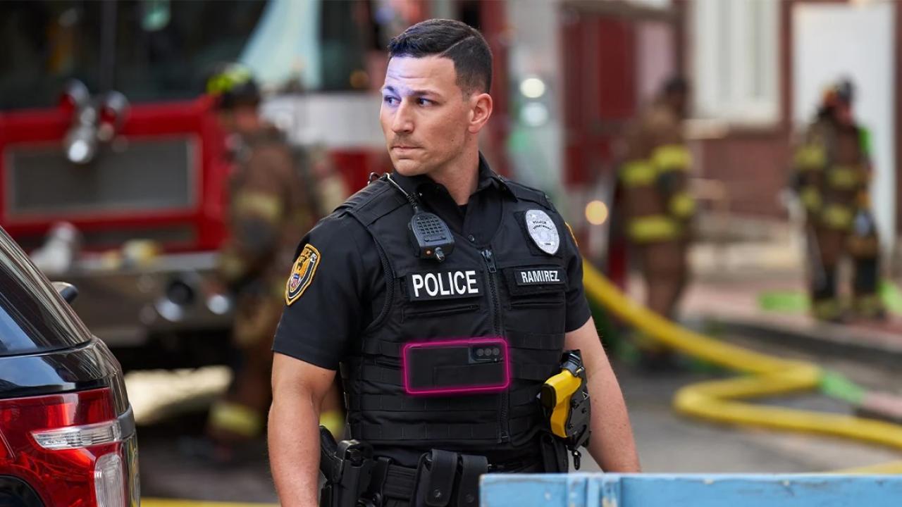 Policeman standing near firefighters on a city street