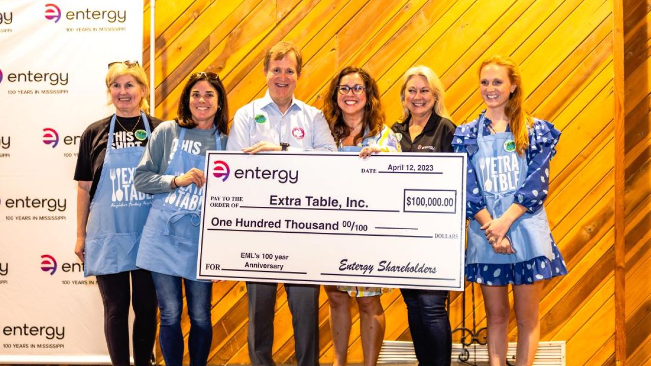 employees with an oversized check