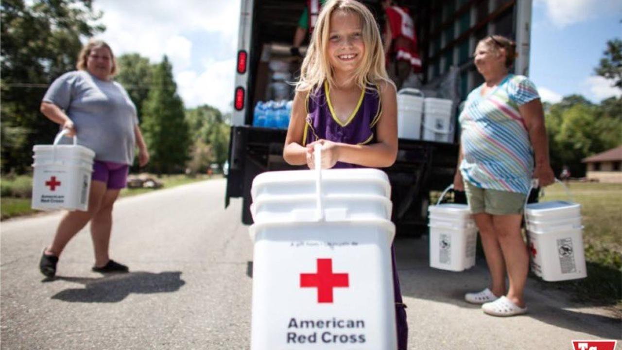 volunteers carry Red Cross buckets