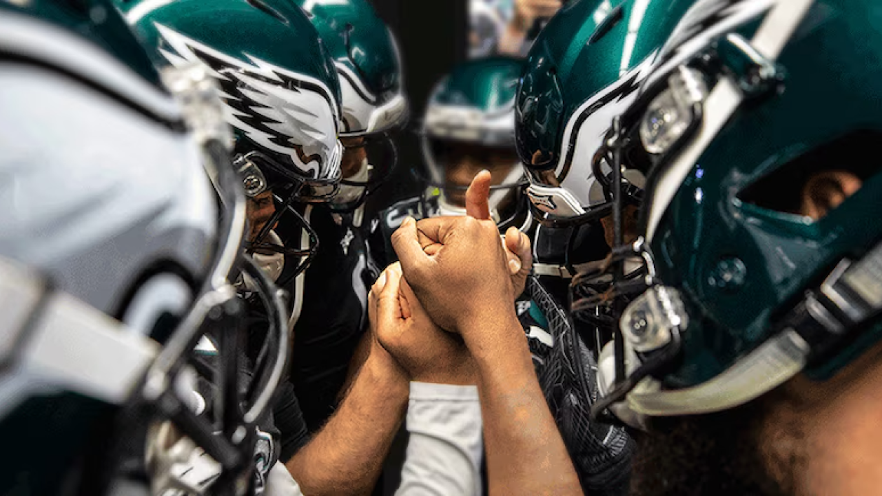 The Philadelphia Eagles shown in a huddle.