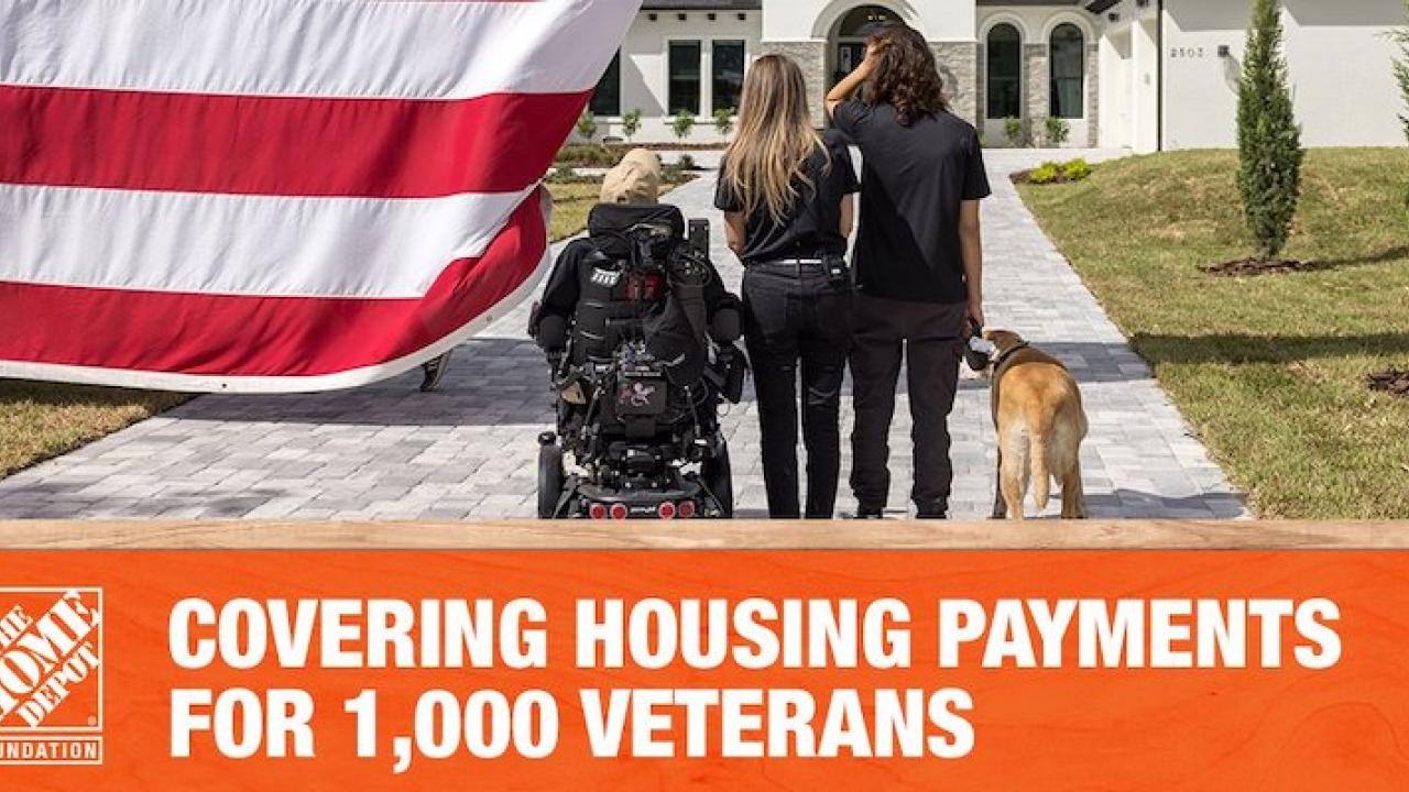 Veteran family shown in front of a house with an American flag.