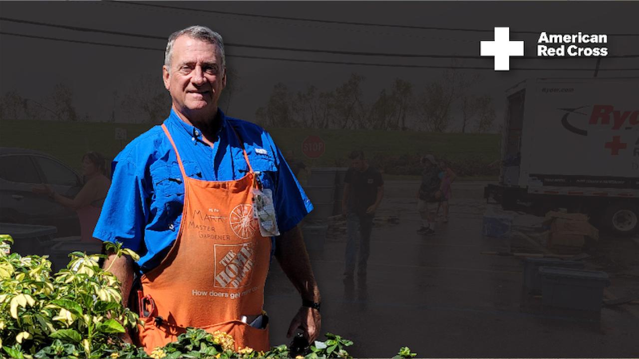 Mark Millia shown in Orange Apron with Red Cross Symbol.