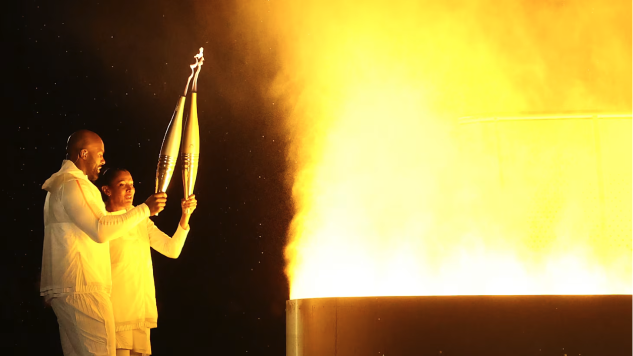 Two people with Olympic torches