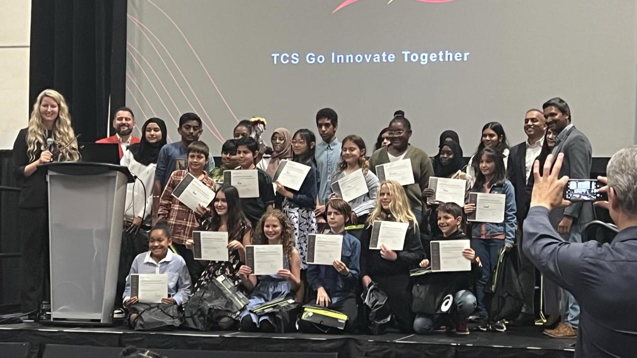 K-12 students pose for photo