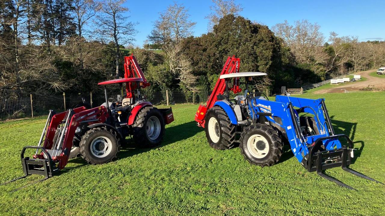 Two tractors parked next to each other in a field