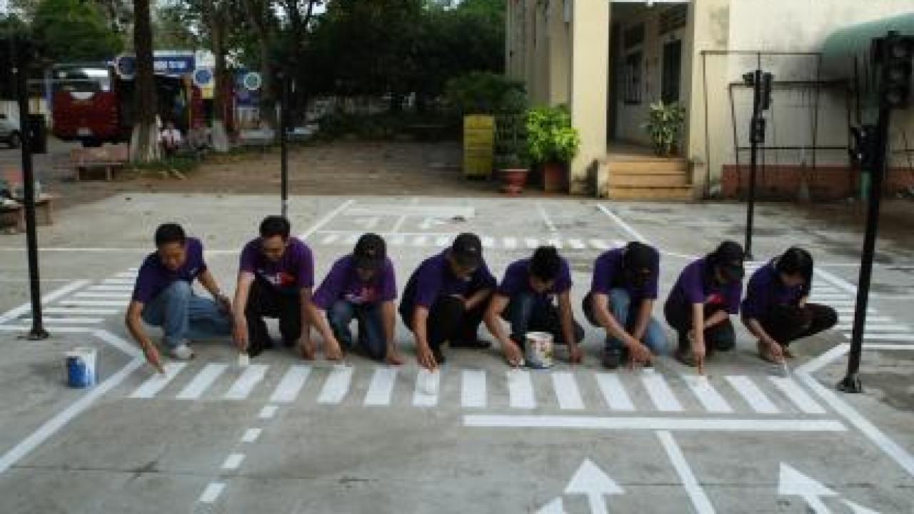 A group of people painting a crosswalk