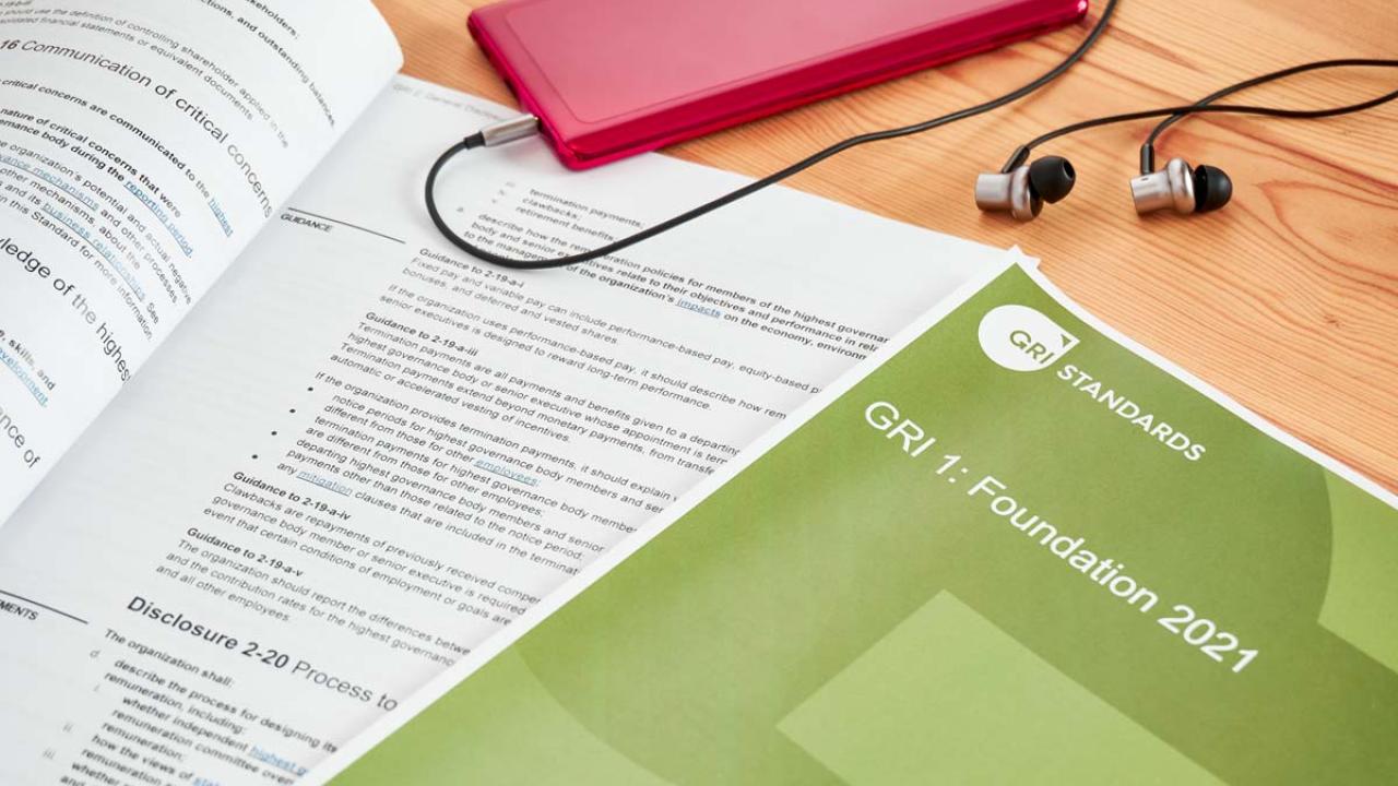 study materials on desk with phone and headphones