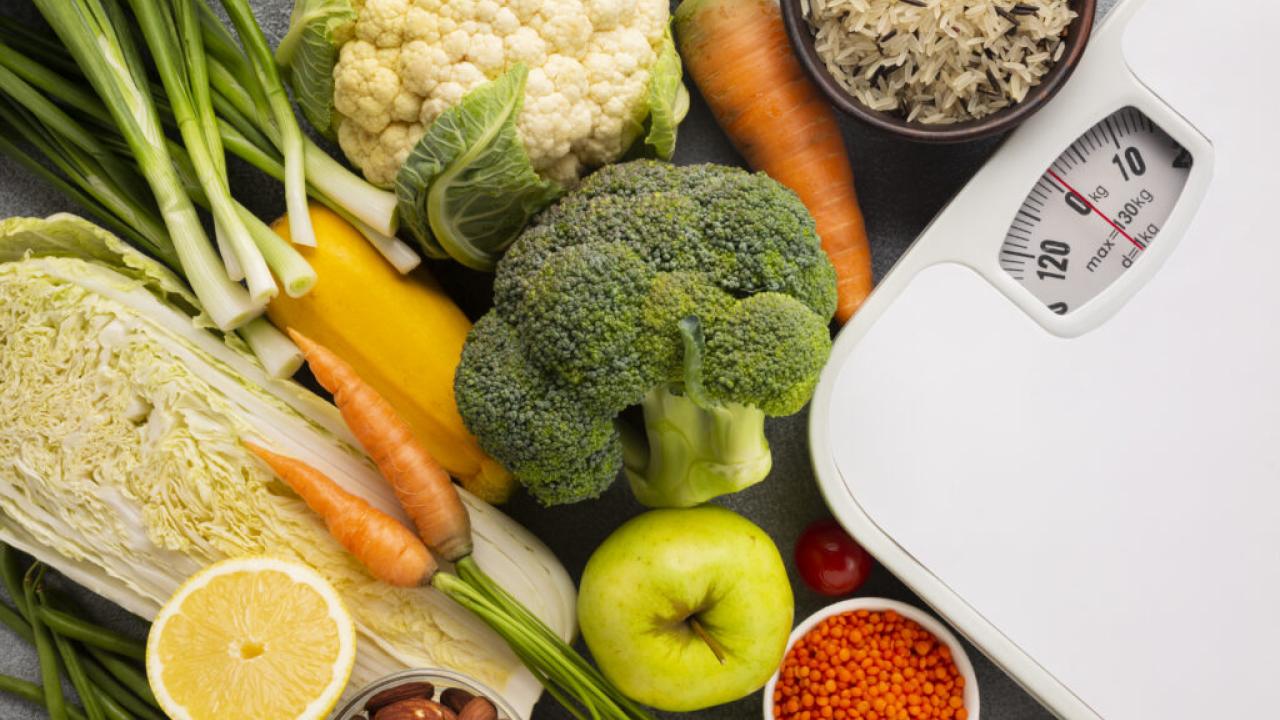 Vegetables and fruits shown near a scale.