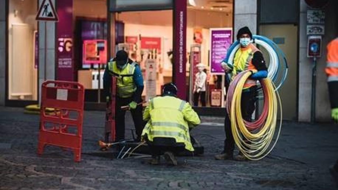 employees on street with cables