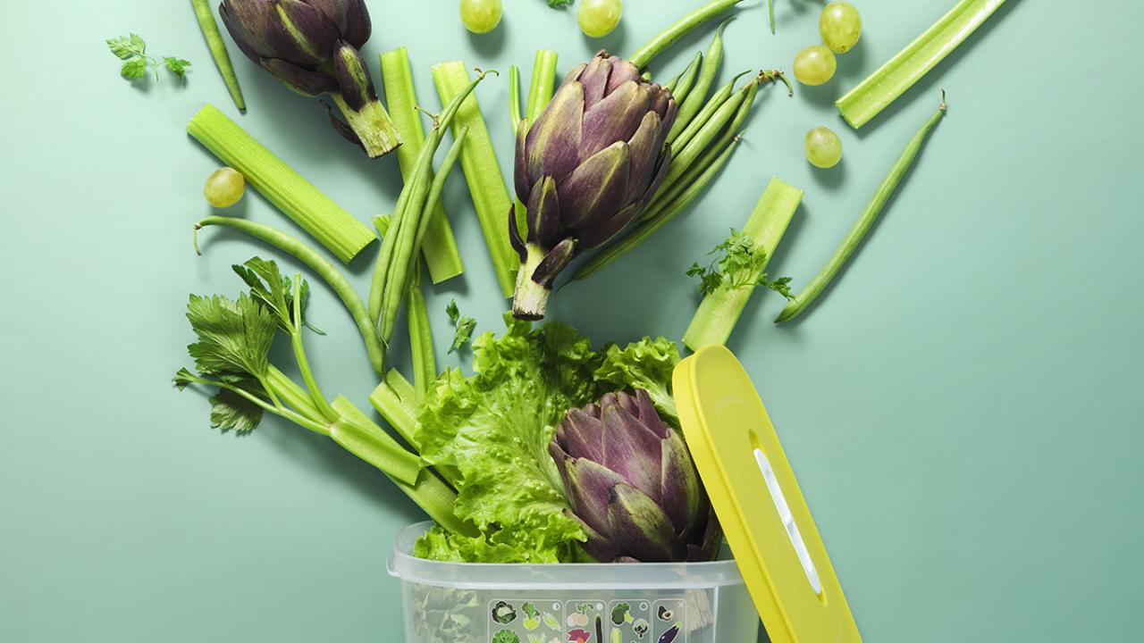 Fruits and vegetables emerging from Tupperware Brands container