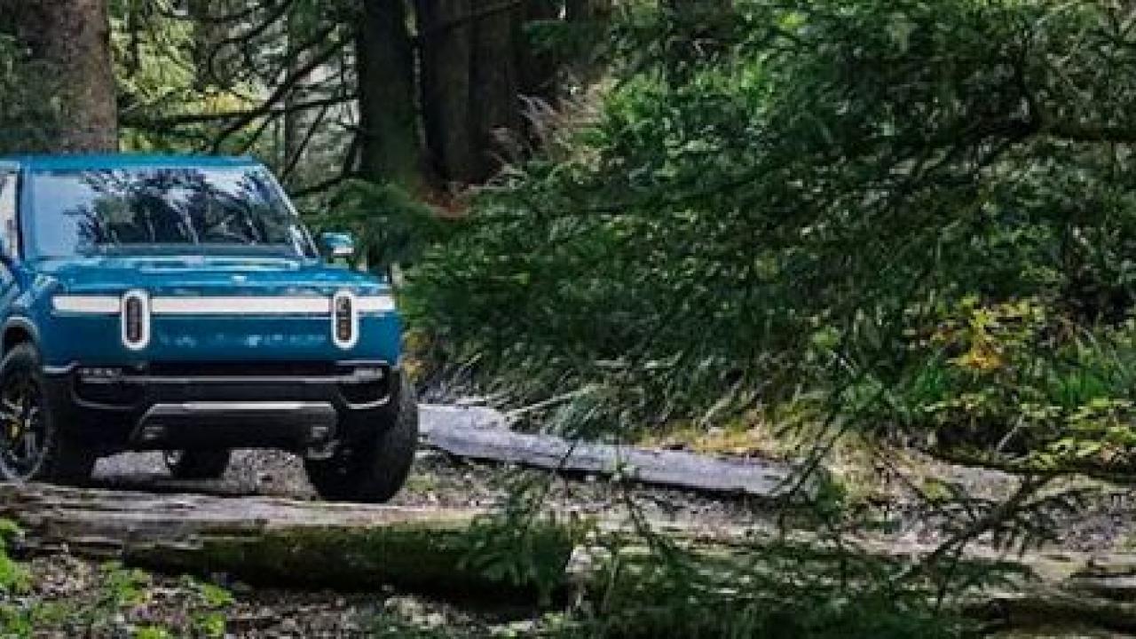 Truck in the woods, with Carbon Neutral Certified logo