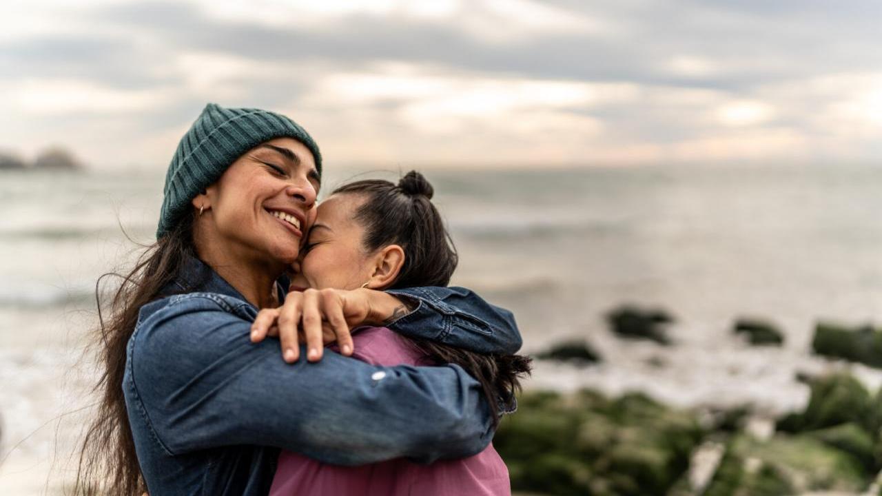 Two people hugging on the beach