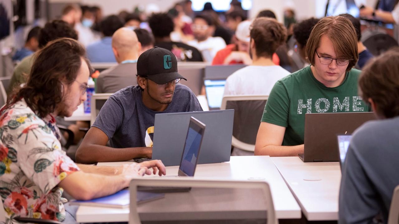group of students working on laptops 