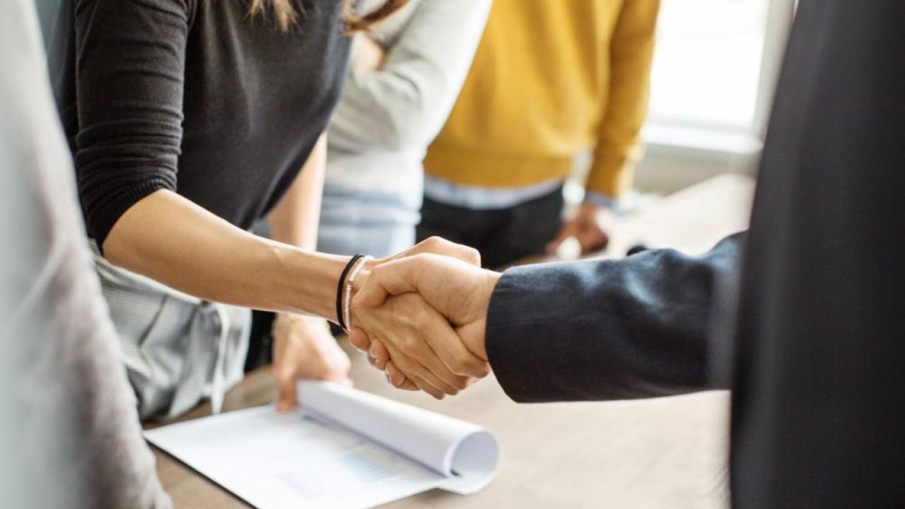 Two people shaking hands.