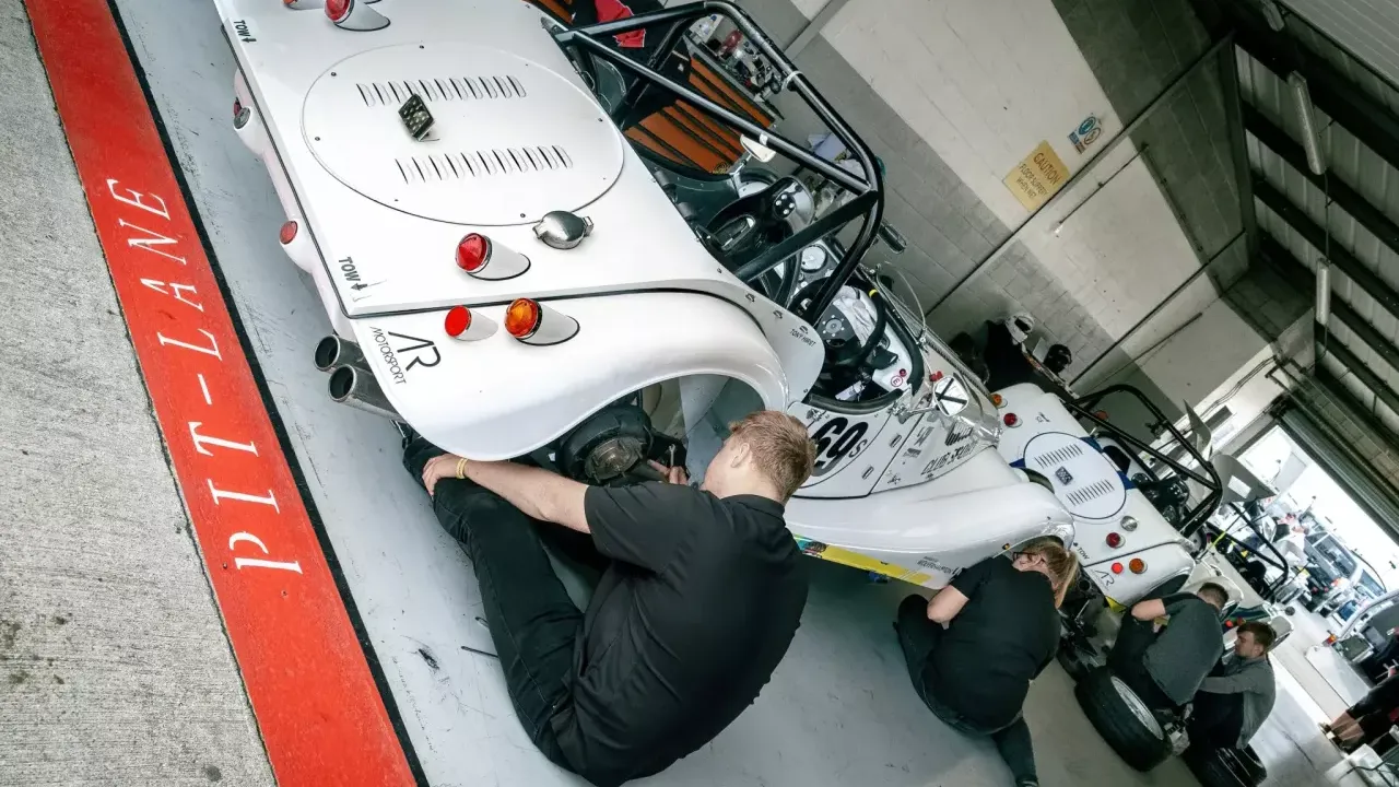 motorsport engineers working on a car