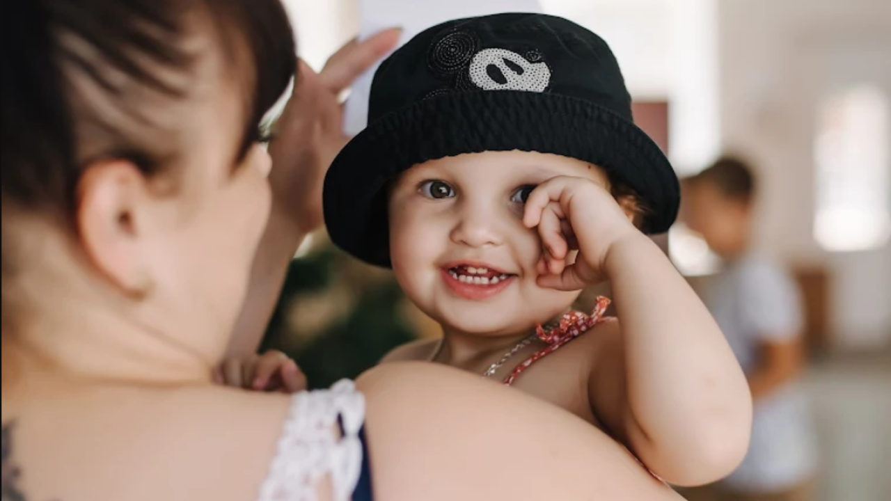 A young child smiles while being held by their mother at a mobile clinic held in Ukraine.