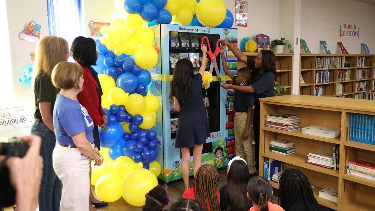 People cutting a ribbon