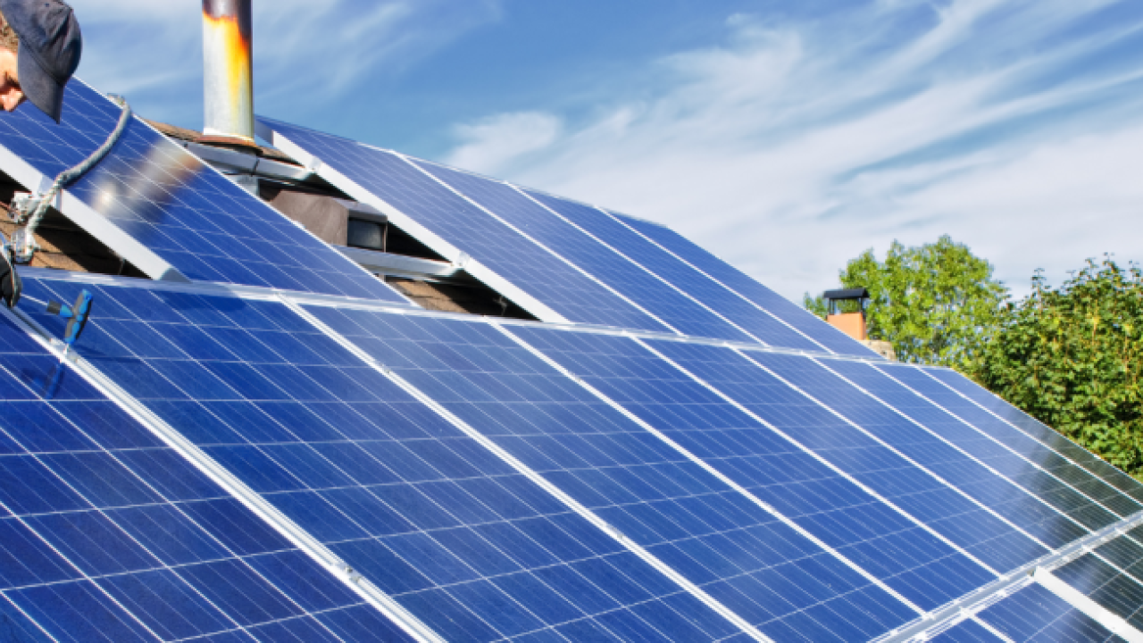 Construction worker installing solar panels