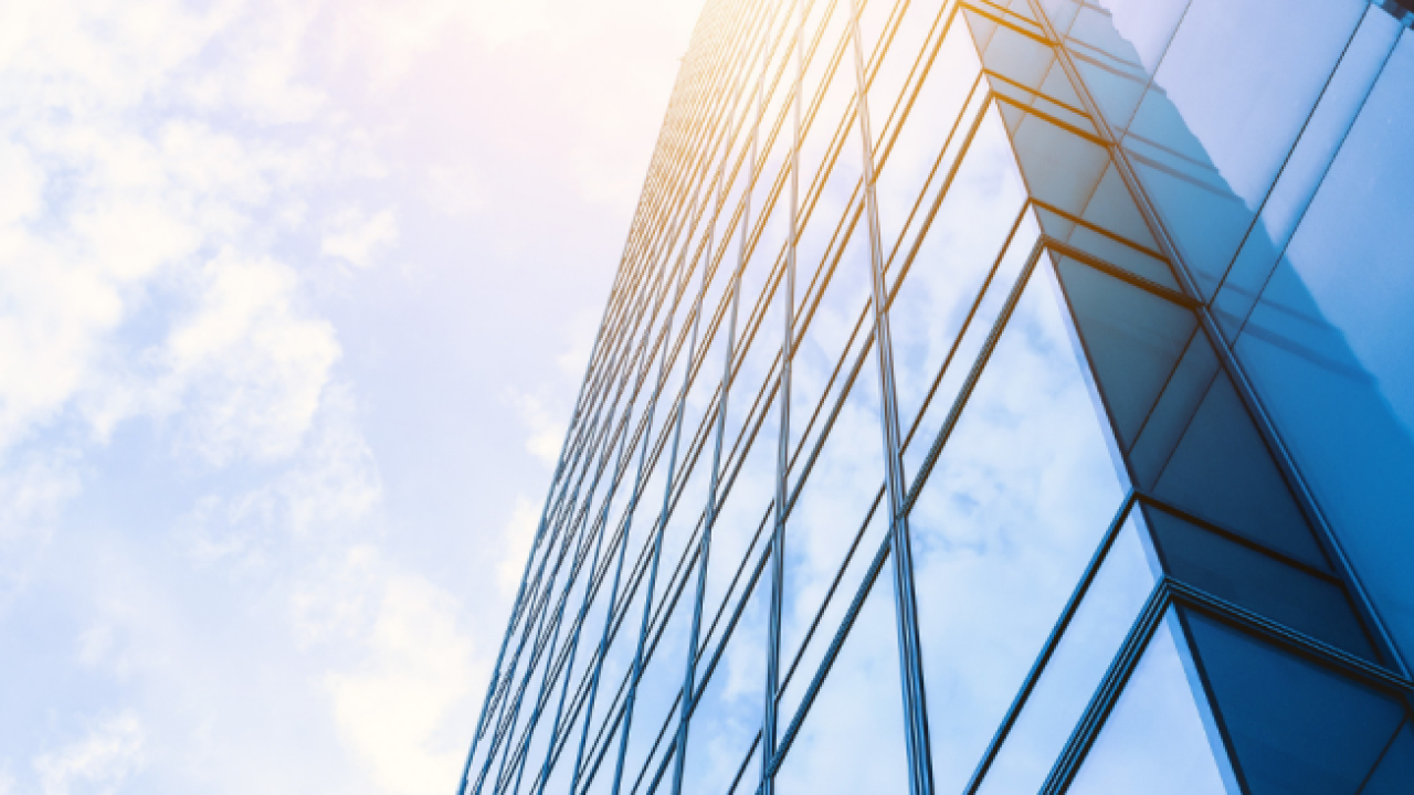 tall, glass building and sky overhead