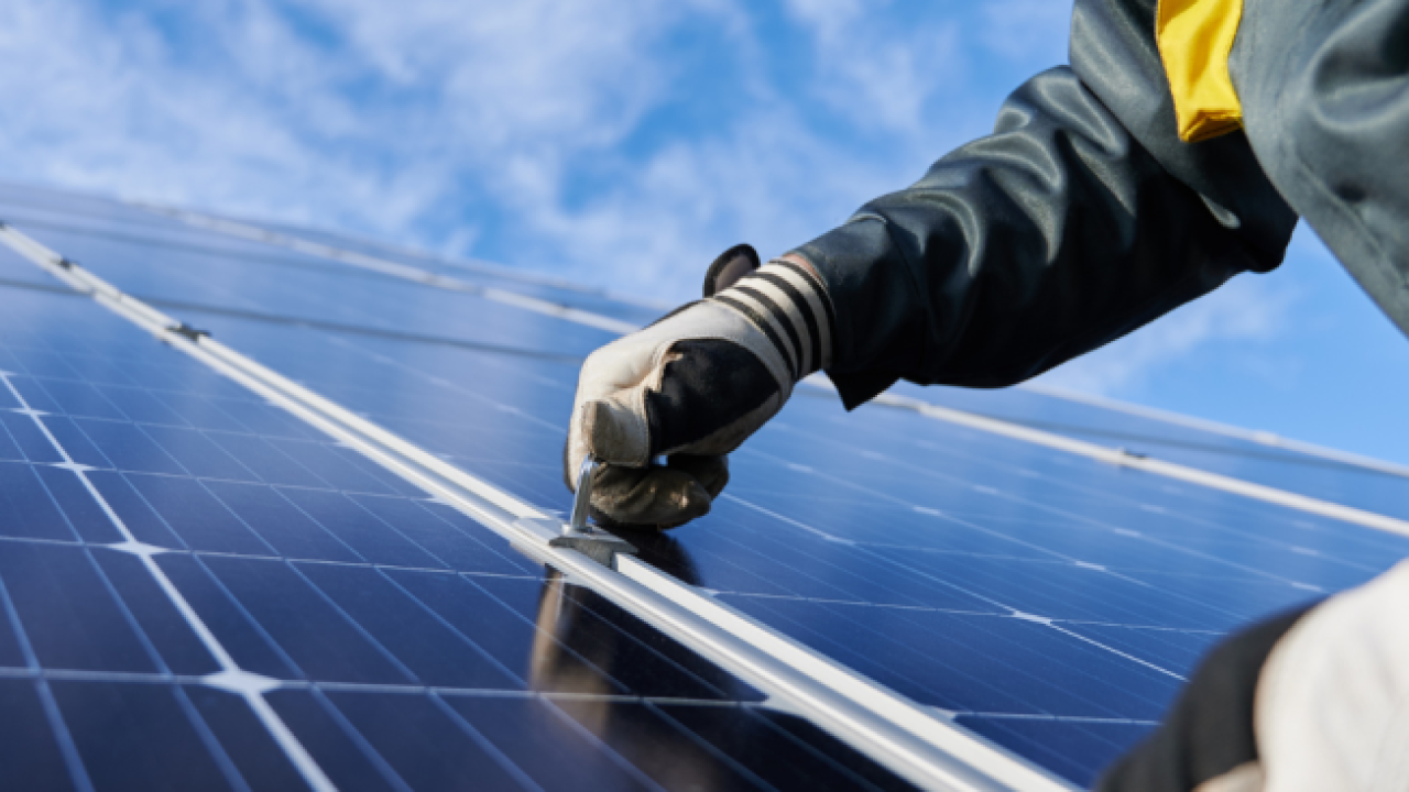 person working on a solar panel