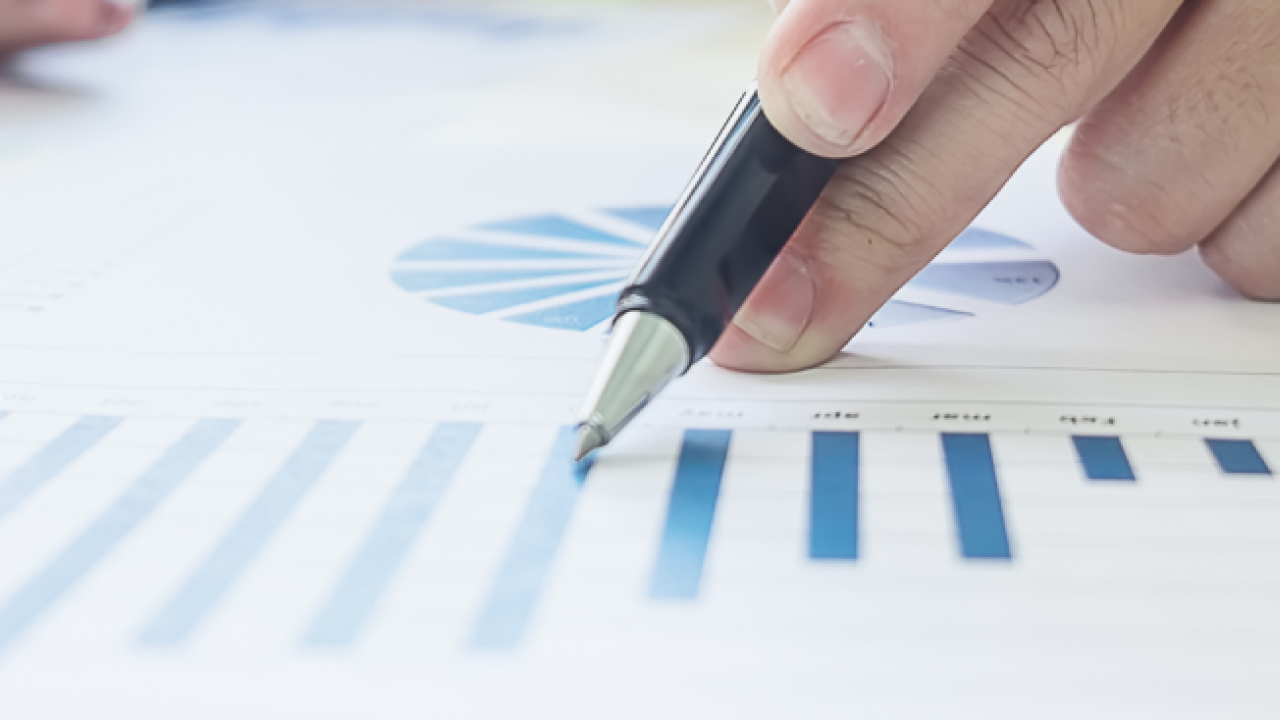 pointing to a graph with a pen