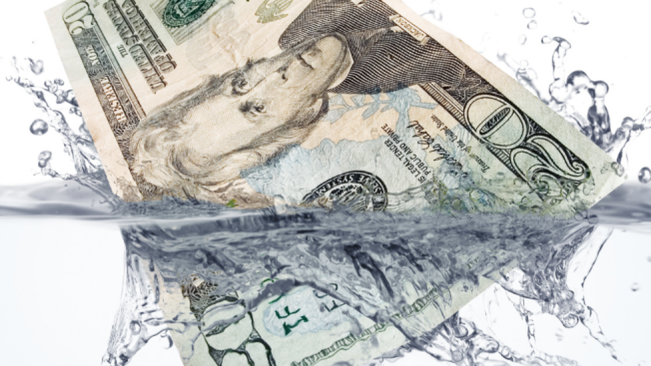 $20 bills dropping into water