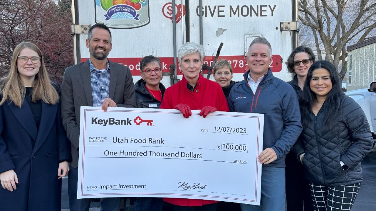 Representatives from KeyBank and the Utah Food Bank shown with a $100,000 grant check.