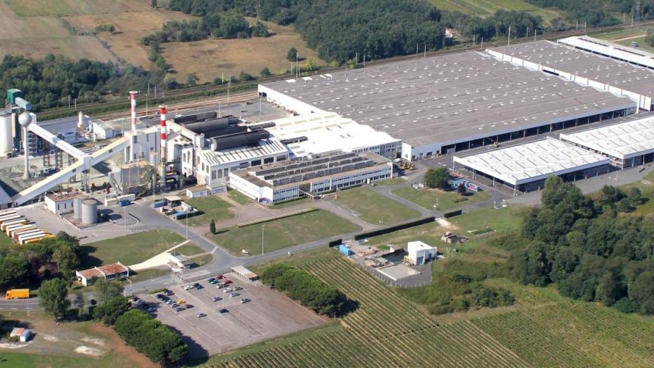 Aerial view of a large building with industrial features.