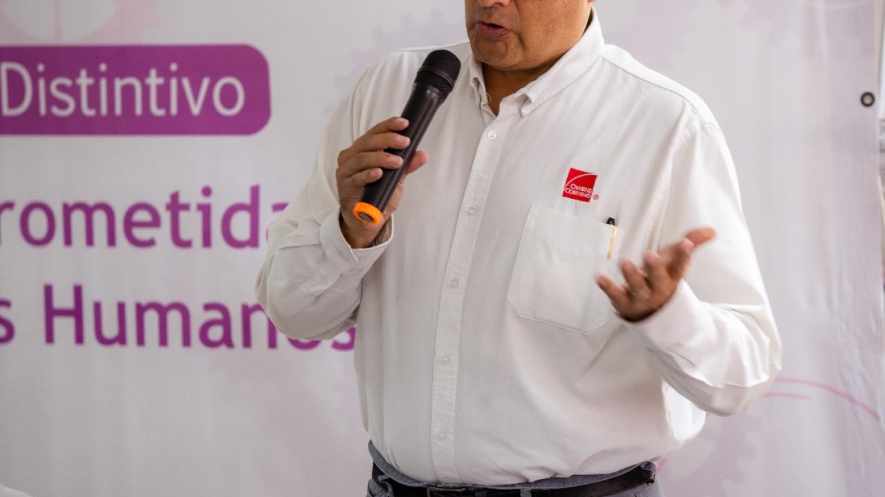 A person stood up talking into a microphone