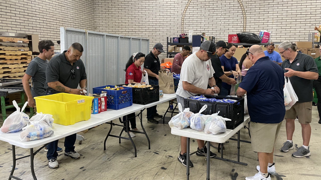 Volunteers packing food bags for homeless individuals and other people in need across the city.