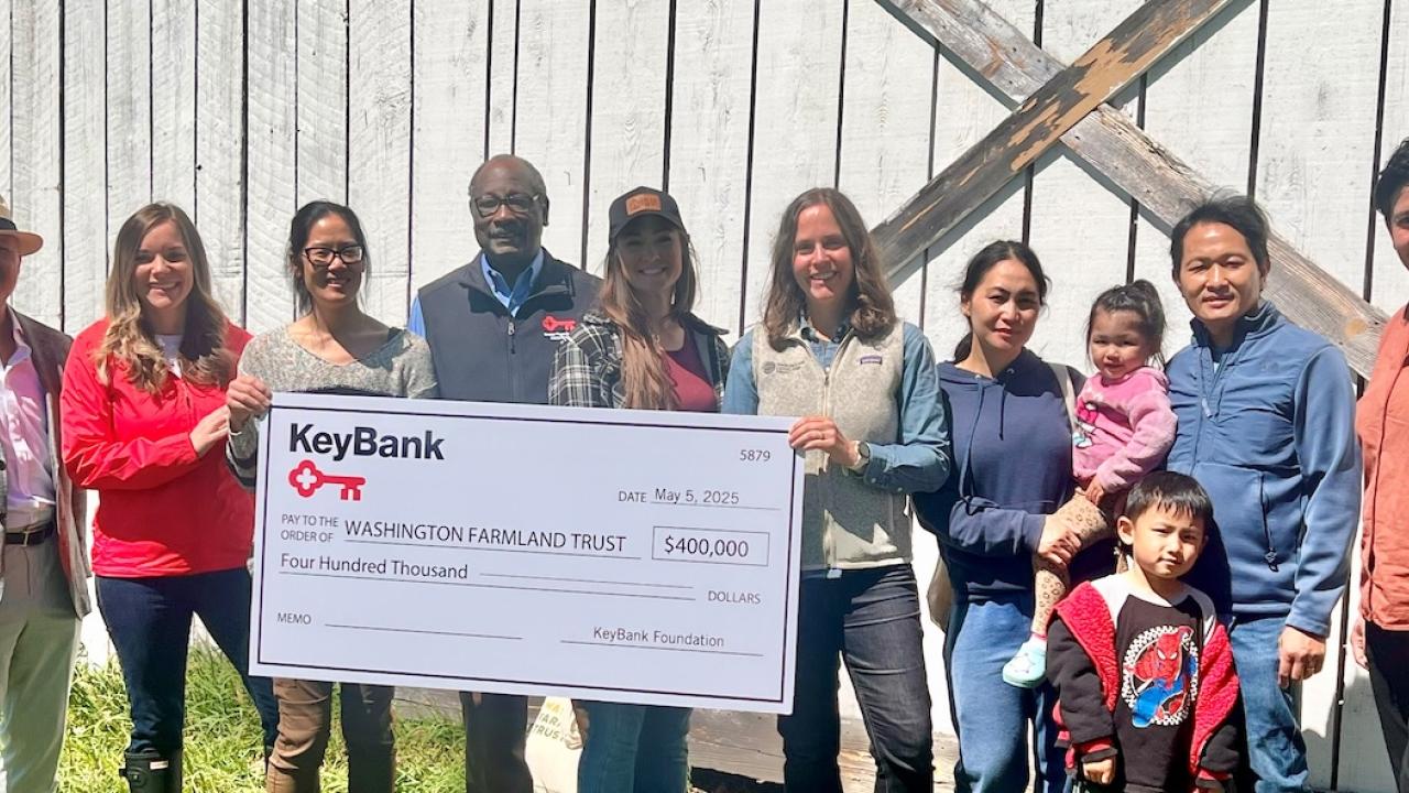 Representatives from KeyBank and Washington Farmland Trust shown with a $400,000 grant check.