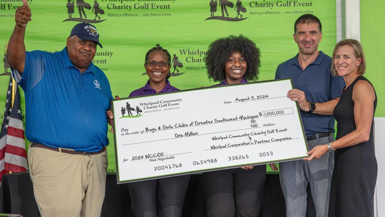 5 people holding up a big check