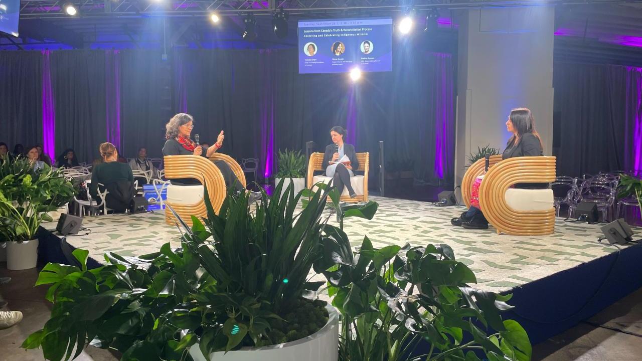 People on stage in chairs
