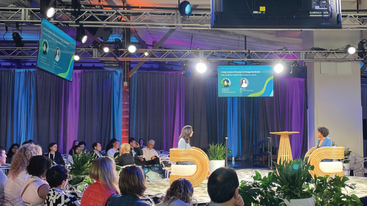 2 people talking on stage