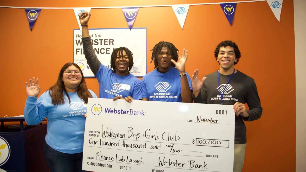 Group celebrating with oversized check