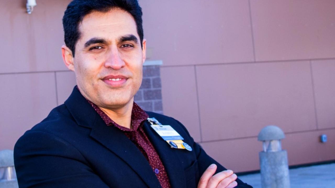 Smiling man with arms crossed