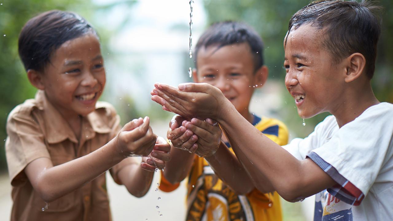 Children catching water in their hands