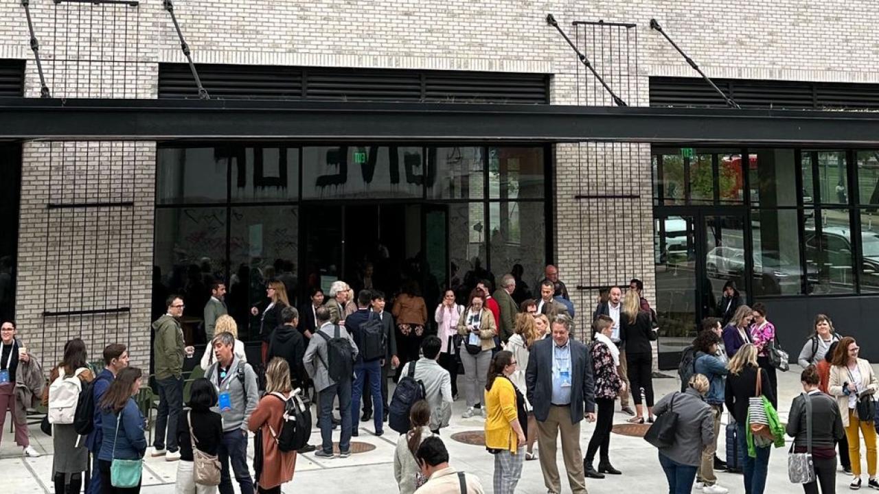 A group of scattered people outside a building