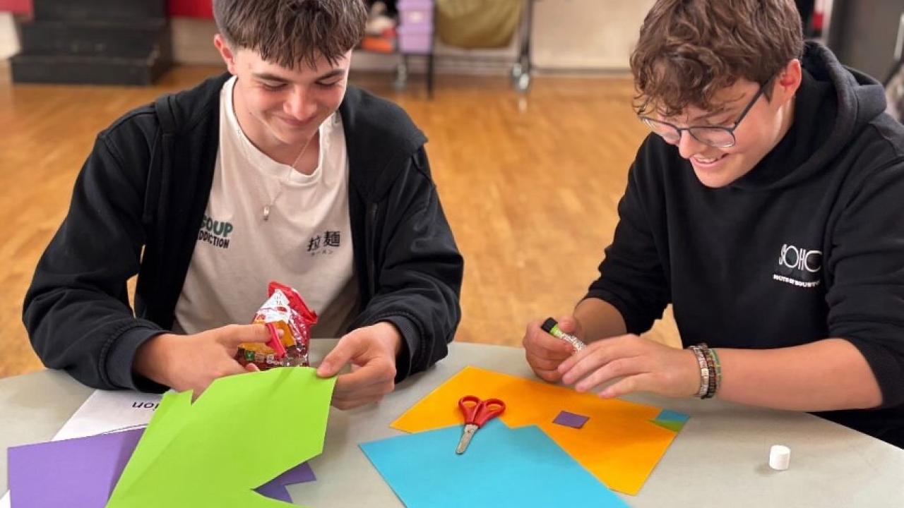 Teenagers shown doing an art project.