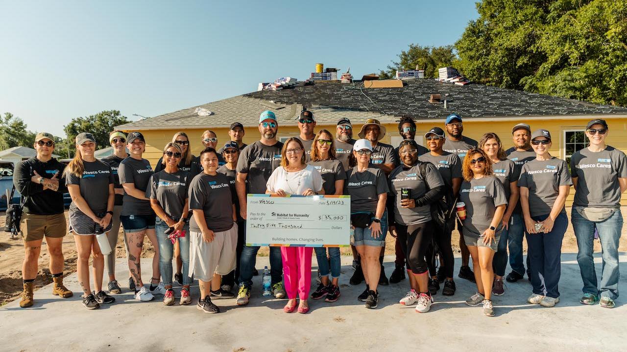 Wesco team with donation check for Habitat.