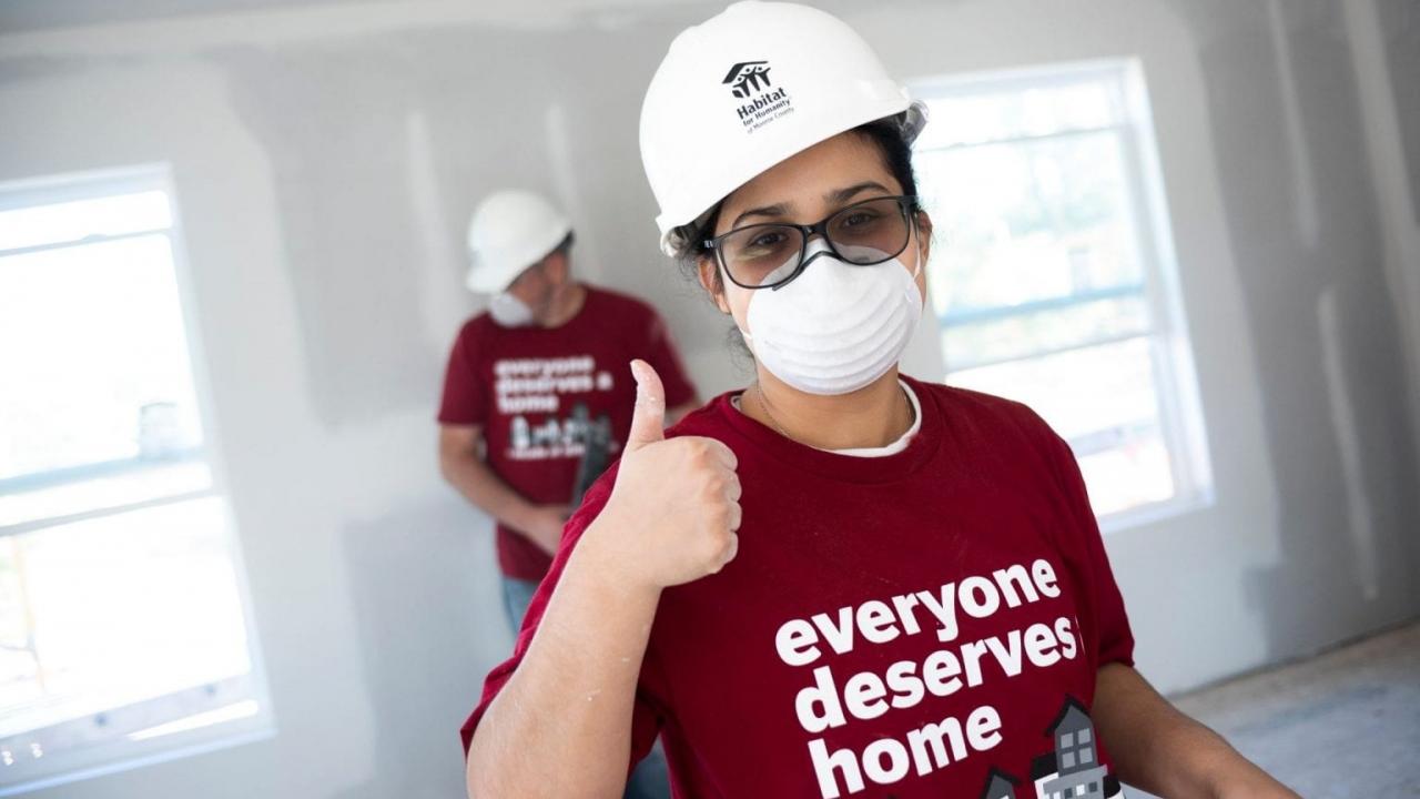 Two volunteers building a home with Habitat for Humanity