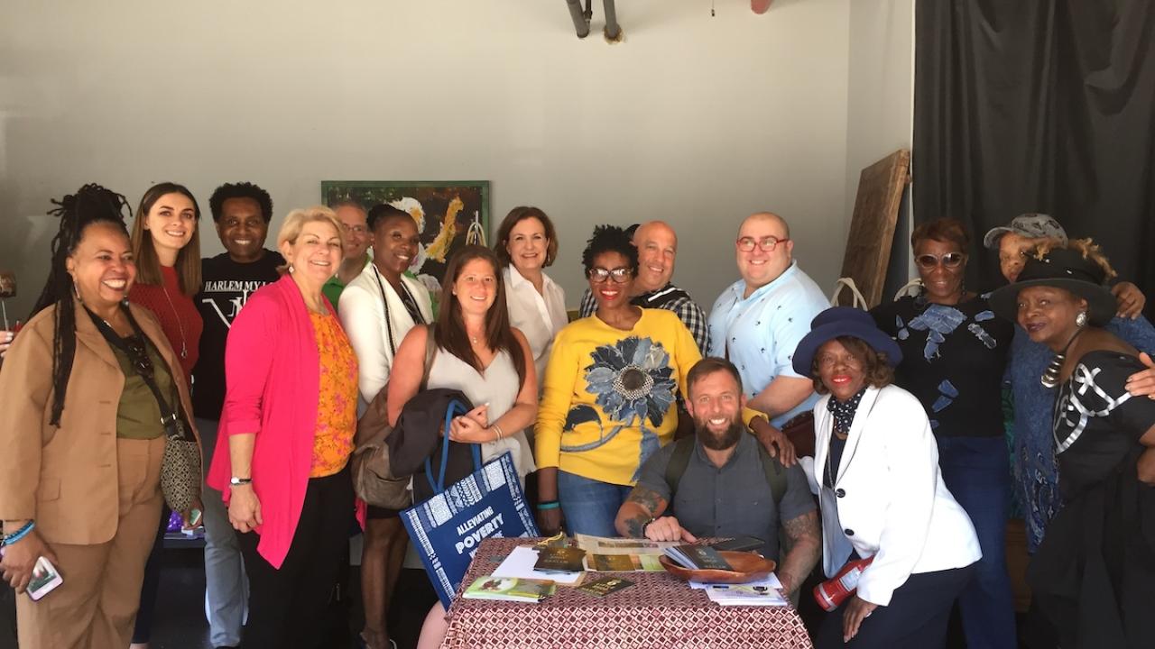 Tropicana Brands Group Philip Coughlin (center, back row) with fellow donors meeting microcredits client on a Whole Planet Foundation Impact Visit in Harlem.