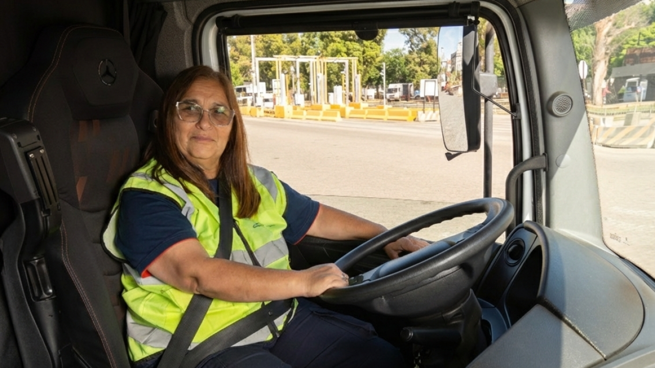 Female truck driver wearing a high-visibility vest operates a truck at DP World’s Buenos Aires terminal.
